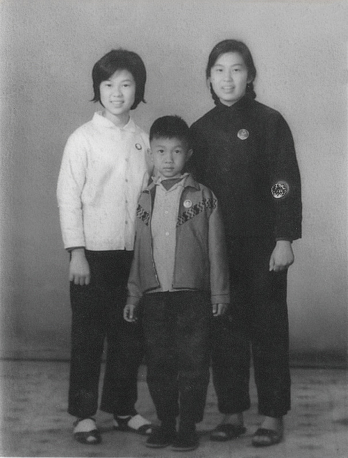 Black and white photograph of three cihldren standing together  in 1990s Hong Kong home – family memory animation