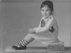 a young girl at a studio photoshoot in 1970s China
