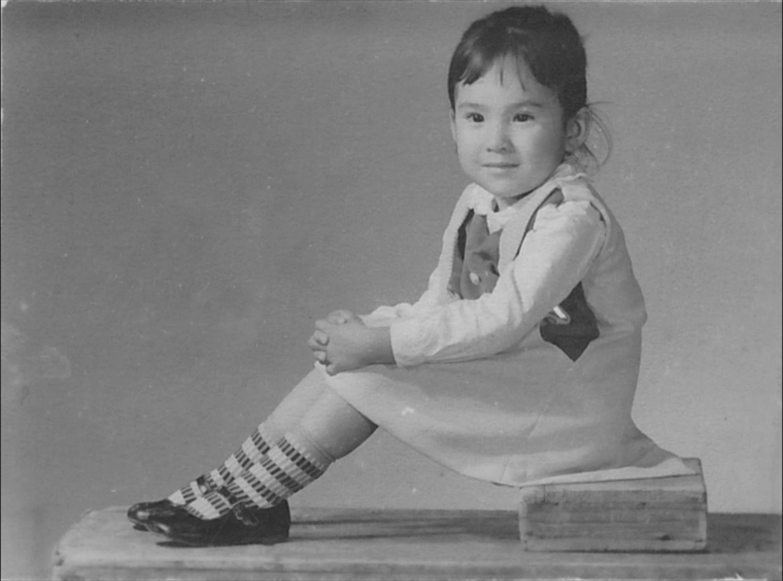 a young girl at a studio photoshoot in 1970s China